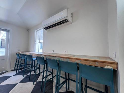 a bar with a row of blue bar stools at K2 Brisbane in Brisbane