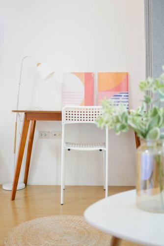 a white chair sitting next to a desk with at sunny islander diving resort in Looc