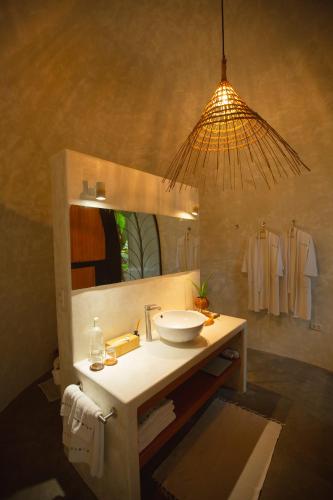 a bathroom with a sink and a mirror at Panorama Boutique Hotel & Beach Club in El Nido