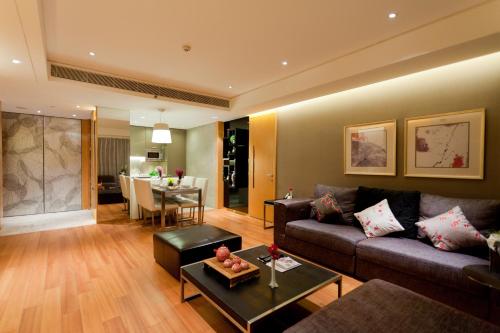 a living room with a couch and a table at Ascott Raffles City Beijing in Beijing