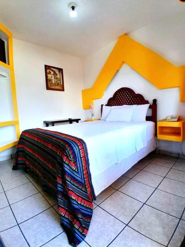 a bedroom with a large bed in a room at Hotel Esmeralda in Poza Rica de Hidalgo