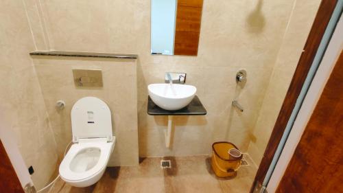 a small bathroom with a sink and a toilet at Hotel Babylon Elegance near krishna janam bhoomi in Mathura