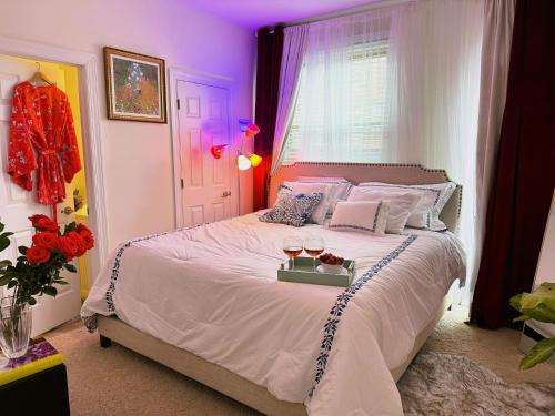 a bedroom with a large bed with purple lighting at Art Downtown Fulton Market Entire 3 bedroom Home Sleep10 Private Garage Roof EV Tesla in Chicago