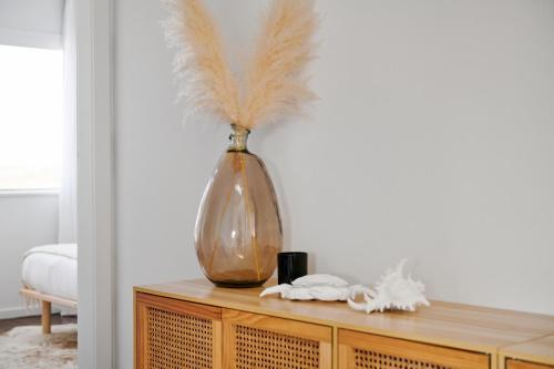 a vase sitting on top of a wooden cabinet at The Shack at Harrington in Harrington