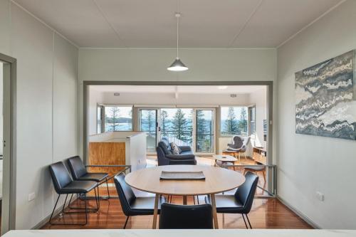 a living room with a table and chairs at The Boat House in Hallidays Point