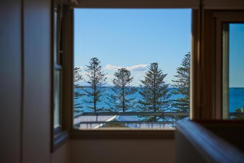 a view of the ocean from a window at The Boat House in Hallidays Point
