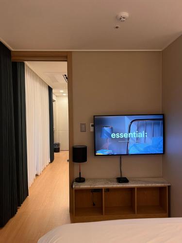 a room with a flat screen tv on a wall at Haeundae La Mer in Busan