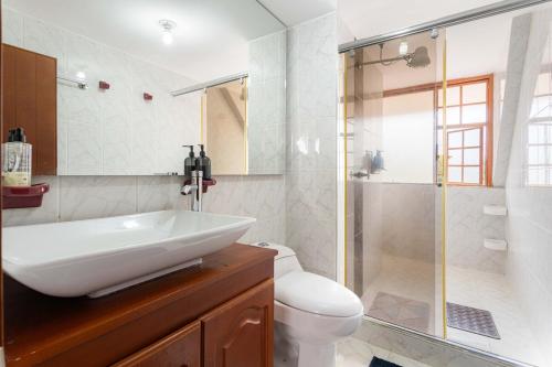 a bathroom with a sink and a shower and a toilet at Country house with fireplace and mountain view in Ubaté