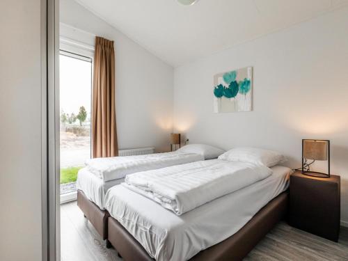 a bedroom with two beds and a window at Holiday Home Bemelen near Bemelerberg Reserve in Bemelen