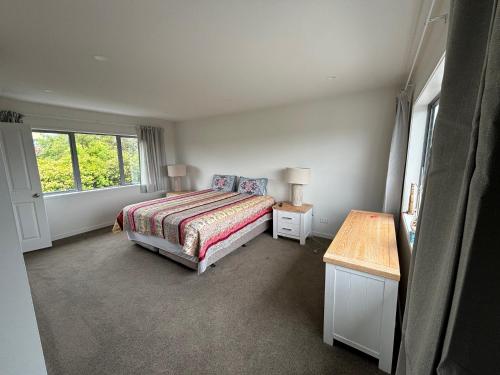 a bedroom with a bed and a window at Dream House 2 in Auckland