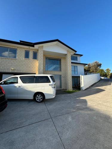 a white van parked in front of a house at Dream House 2 in Auckland