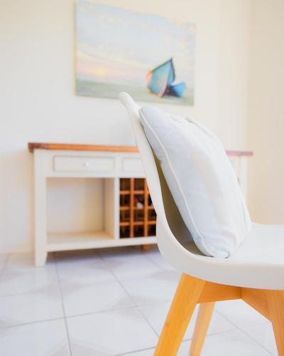 a white chair sitting in front of a desk at High Haven Black Head Village in Hallidays Point