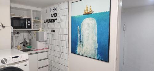 a kitchen with a painting on the wall at stay bnb 206 in Seoul