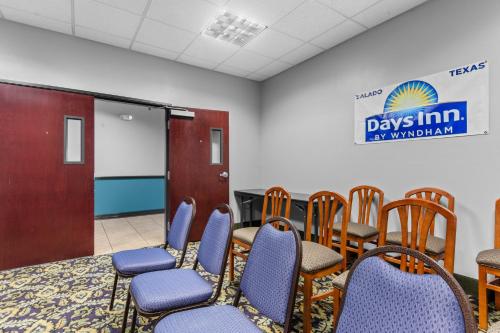 a waiting room with chairs and a chalk board at Days Inn by Wyndham Salado in Salado