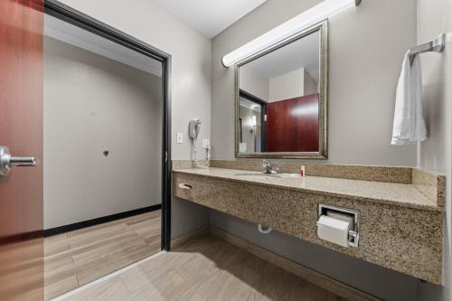 a bathroom with a sink and a mirror at Days Inn by Wyndham Salado in Salado
