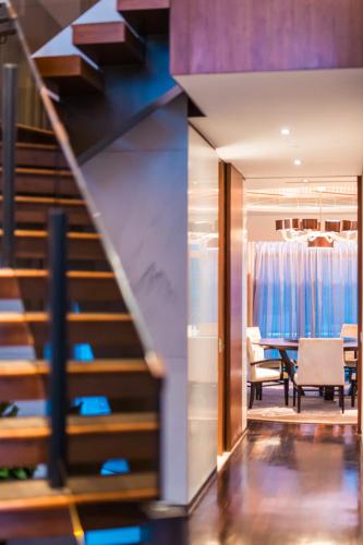 a staircase leading to a dining room with a table at The Langham, Shanghai, Xintiandi in Shanghai