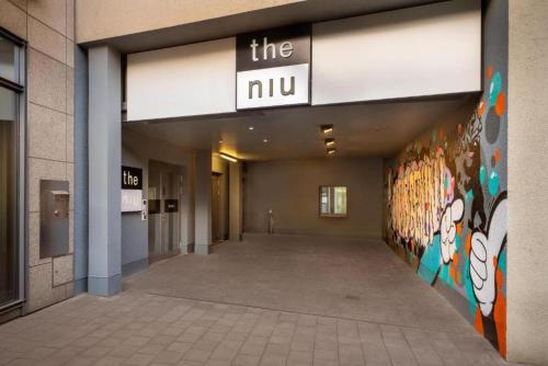 an empty hallway of a building with a sign on it at Holiday Inn - the niu, Hide Berlin Friedrichshain by IHG in Berlin