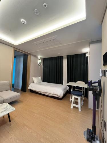 a hotel room with a bed and a table at Haeundae La Mer in Busan