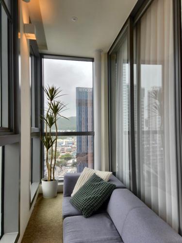 a living room with a couch and a large window at Haeundae La Mer in Busan