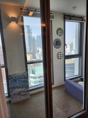 a room with a large window with a view of a city at Haeundae La Mer in Busan