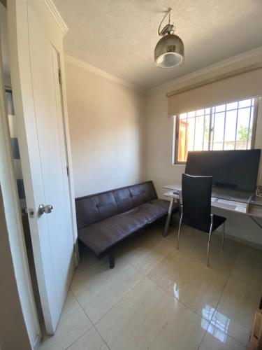a living room with a couch and a table at Casa Amplia y Comoda SyS Suites in Chicureo Abajo