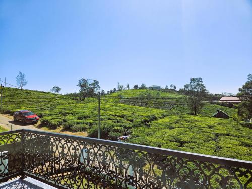 a balcony with a view of a tea plantation at Private Villa by the Tea Estate in Nuwara Eliya