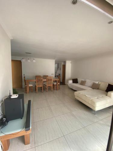a living room with a couch and a table at Casa Amplia y Comoda SyS Suites in Chicureo Abajo