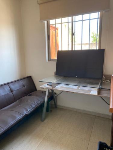 a living room with a table and a couch at Casa Amplia y Comoda SyS Suites in Chicureo Abajo
