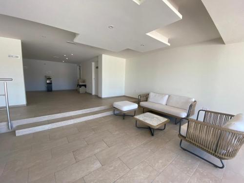 an empty waiting room with a couch and chairs at Ocean&airport view condo with pool&gym in Maho, walk to Maho Beach and Mullet Bay in Maho Reef