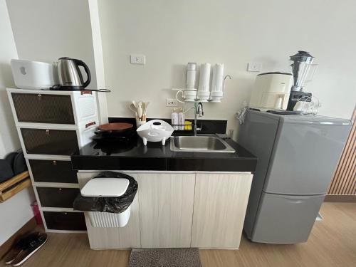 a small kitchen with a sink and a refrigerator at Aras Solace Place in Trece Martires