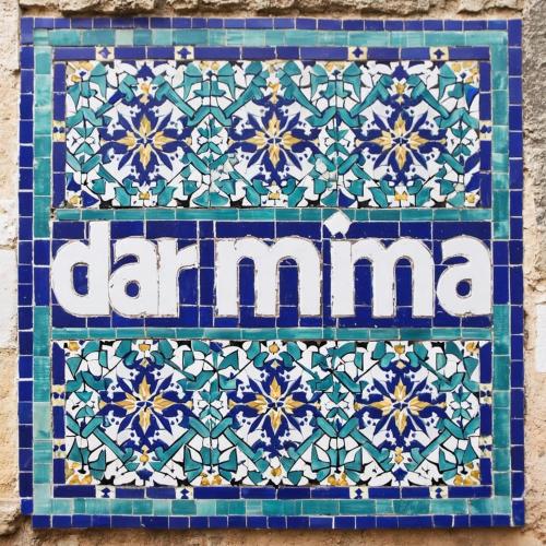 a tile with the word clamana on a wall at Dar Mima in Fès