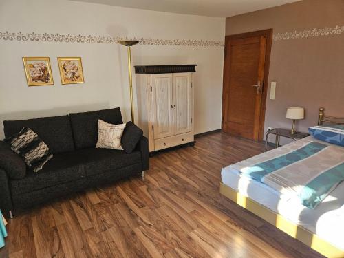 a living room with a bed and a couch at Ferienhaus Gottschlicht Bei Rottach Egern Am Tegernsee, Eigener Parkplatz, W Lan in Rottach-Egern