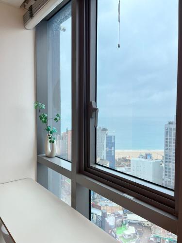 a window with a view of a city at Haeundae La Mer in Busan