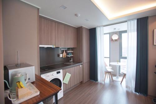 a kitchen with a washer and dryer in a room at Haeundae La Mer in Busan