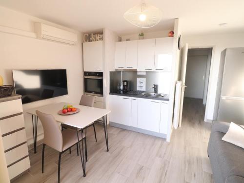 une cuisine avec une table avec un bol de fruits dessus dans l'établissement Magnifique T2 climatisé avec parking privé à Sète - FR-1-472-207, à Sète