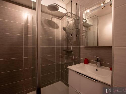une salle de bain avec douche et lavabo dans l'établissement Studio rénové avec jardin et accès piscine - FR-1-825-19, à La Rochelle