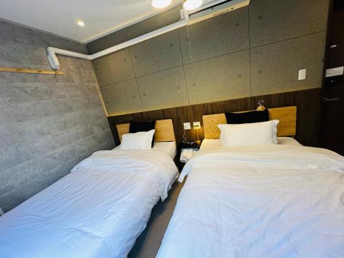 Postel nebo postele na pokoji v ubytování e-hostel 心斎橋 双床房