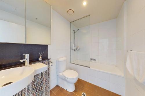 a bathroom with a toilet and a sink and a shower at Cloud 17 Retreat - Meriton Soleil Private Apt 1B in Brisbane