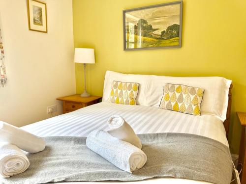 a bedroom with a bed with towels on it at Pass the Keys Y Bwythn Welsh Countryside Retreat UK Getaway in Carmarthen