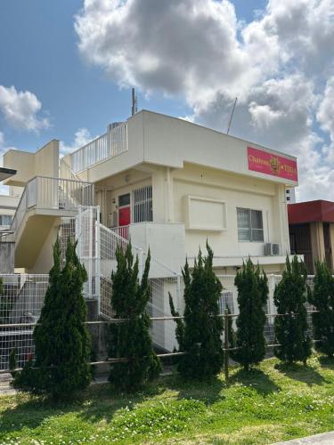 a building with christmas trees in front of it at Chateau TIIDA 国際通り徒歩5分 in Asato