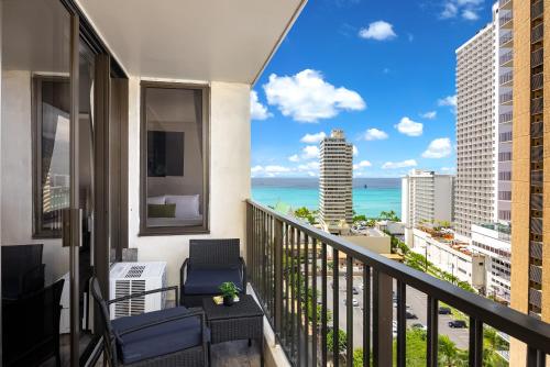 a balcony with chairs and a view of the ocean at 18Fl Ocean Views, AC, Parking, Near Waikiki Beach in Honolulu