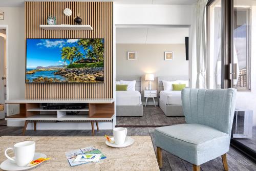 a living room with a tv and a couch at 18Fl Ocean Views, AC, Parking, Near Waikiki Beach in Honolulu
