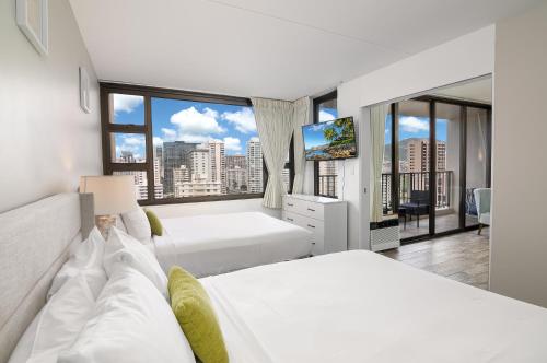 a bedroom with two beds and a large window at 18Fl Ocean Views, AC, Parking, Near Waikiki Beach in Honolulu