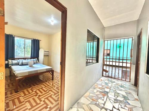 a room with a bed and a window at Carillo guest house in Coron