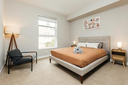 a bedroom with a bed and a chair and a window at Magnificent two bedroom in West Hollywood in Los Angeles