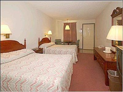 a hotel room with two beds and a desk at Mountain Empire Motel in Mountain City