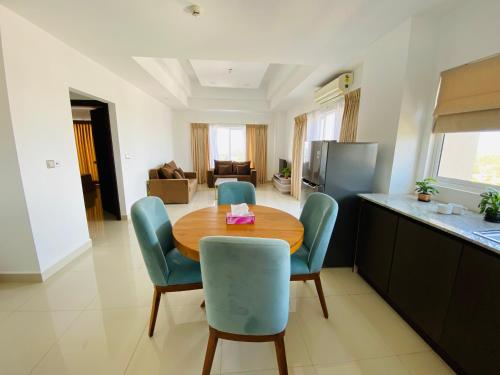 a kitchen and dining room with a wooden table and chairs at Eco Breeze Negombo in Negombo