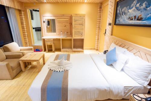 a bedroom with a large bed and a bathroom at Trekkers Inn Boutique Hotel Pokhara in Pokhara
