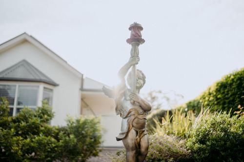a statue of a woman holding a umbrella at Domaine du Moine in Oakhampton