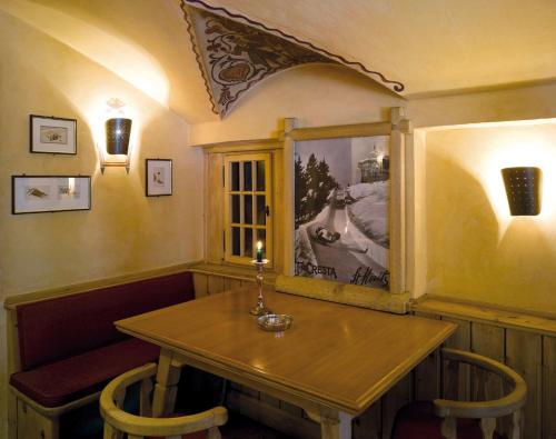 a dining room with a table with a candle on it at Hotel Steffani in St. Moritz
